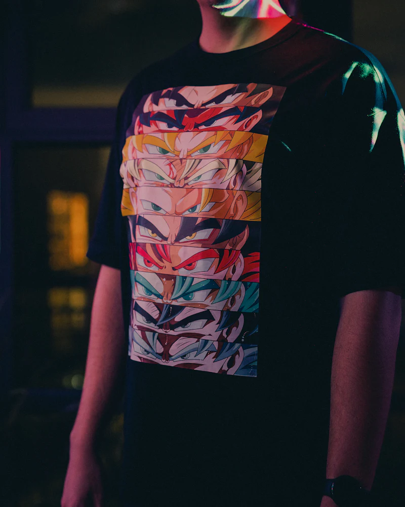 Person wearing a black t-shirt with a bold full-color graphic print
