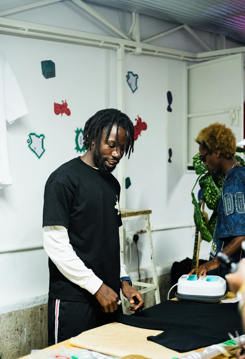 Man placing a black t-shirt on a heat press for a DTF transfer