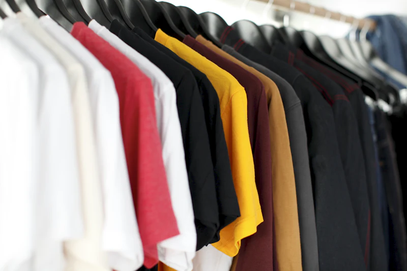 Rack of t-shirts in assorted colors on hangers